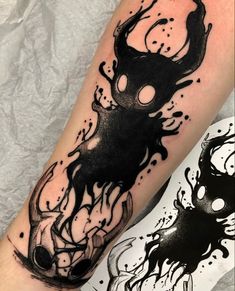 a black and white tattoo on the leg of a person with ink splatters