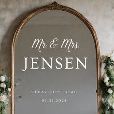 a mirror with the words mr and mrs written on it next to some white flowers