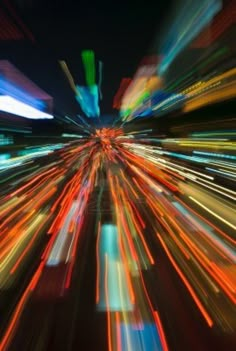 blurry image of city lights at night with long exposure and color to the foreground