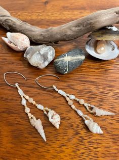 The 'Mermaid's Delight' earrings will transport you to a warm day at the coast with your toes in the sand and the sunlight glinting off the waves. Two different small shells dangle at the bottom of each earring. Mother of pearl, freshwater pearl, heishi shell, and peach and cream colored round shell beads, and white, matte cream, and reflective gold glass seed beads decorate them. They are light weight, unique, and made with beautiful natural treasures. You may not be able to be at the beach everyday, but you can wear a little bit of it through your everyday life! Beaded Shell Earrings, Shell Beaded Jewelry, Beachy Shell Dangle Earrings, Handmade Beaded Earrings For Beach, Handmade Ocean-inspired Earrings For Beach, Handmade Adjustable Ocean-inspired Earrings, Ocean-inspired Shell Earrings With Ear Wire, Handmade Beachy Dangle Earrings, Handmade Beachy Drop Earrings