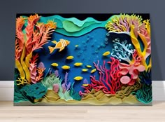 an underwater scene made out of paper with fish, corals and other marine life