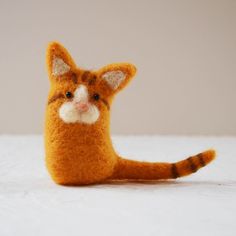 a small stuffed animal sitting on top of a bed