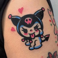 a cartoon character tattoo on the side of a woman's thigh, with hearts in the background