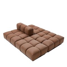 a large brown couch sitting on top of a white floor