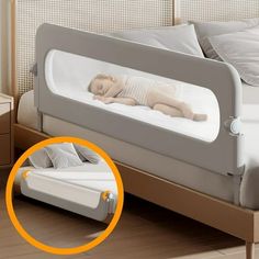 a baby laying on top of a bed next to a night stand with an orange circle around it