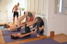 a group of people doing yoga in a room