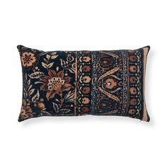 a black and brown pillow with floral designs on it