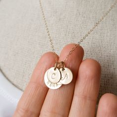 "Gold filled Nana necklace personalized with initials. A sweet and simple gift for grandma, that she will truly cherish. Personalized with grandchildren's initials. Dainty, timeless, perfect for every day. FEATURES: * high-quality gold filled discs are hand finished, * the large disc is carefully hand stamped with the word \"NANA\", * small discs will be stamped with initials of your choice, * delicate gold filled chain is finished with a spring clasp closure. MEASUREMENTS: * 14K gold filled lar Everyday Personalized Initial Pendant Necklace, Customizable Initial Pendant Charm Necklace For Mom, Personalized Initial Pendant Charm Necklace For Mom, Mother's Day Initials Charm Necklaces For Mom, Mother's Day Initials Charm Necklace Gift For Mom, Mother's Day Gift Initials Charm Necklaces, Initial Pendant Necklace As Gift For Mom, Mother’s Day Gift Initials Charm Necklaces, Customizable Initial Pendant Necklace For Mom