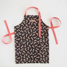 a black apron with pink and white sprinkles on it