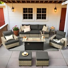 an outdoor living area with wicker furniture and potted plants