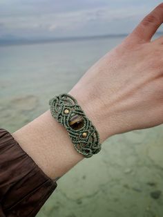 a person's hand with a bracelet on it