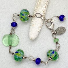 Bracelet: Lime and Blue Handmade Artisan Glass – Bluemangroveart Artisan Blue Jewelry With Recycled Glass, Artisan Blue Recycled Glass Jewelry, Artsy Nickel-free Blue Jewelry, Artsy Blue Nickel-free Jewelry, Handmade Adjustable Blue-green Jewelry, Adjustable Czech Glass Artistic Jewelry, Handmade Beaded Bracelets In Sterling Silver With Fusion Style, Artistic Blue Beaded Jewelry, Handmade Blue Glass Bracelets