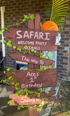 a wooden sign that says safari welcome party