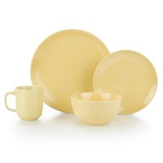 yellow dinnerware set with matching cups and saucers