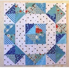 a blue and white patchwork quilt on a table