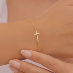 Description Sideways Cross Bracelet, Gold Cross Bracelet, Silver Cross Bracelet, Dainty Cross Bracelet ♥ Handmade with love ♥ Free Gift Box and Gift Messages MATERIALS & QUALITY 100% High Quality Necklaces 100% Made on Fine 925 Sterling Silver Chain  14k Gold Plated, Sterling Silver or Rose Gold Plated jewellery. EASY TO ORDER ♥ Please select your preferred chain length and colour from the menu. ♥ Please select your preferred style from the menu. PACKAGING & GIFTS We will package your order in a Affordable Elegant Cross Bracelet, Infinity Necklace With Names, Jesus Jewelry, Gold Cross Bracelet, Packaging Gifts, Silver Cross Bracelet, Cross Charm Necklace, Customized Bridesmaid Gifts, Christian Bracelets