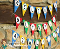 a welcome banner is hanging on a stone wall