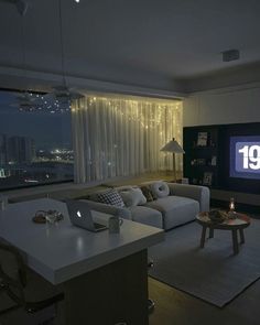 a living room filled with furniture and a flat screen tv mounted to the side of a wall