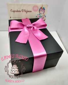 a black box with a pink ribbon on it