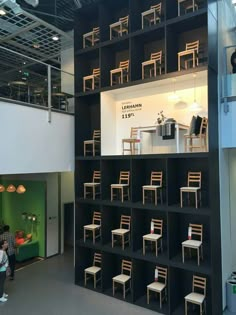 the interior of a furniture store with chairs and tables on shelves in front of them