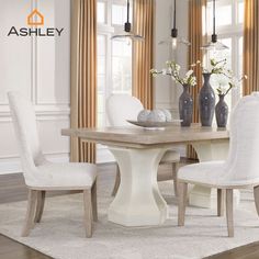 a dining room table with white chairs and vases on top of it, in front of windows