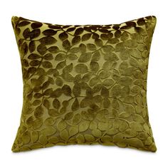 a green and brown pillow on a white background