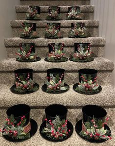 a bunch of hats that are sitting on some steps with holly wreaths and berries