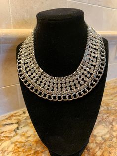 "Stunning rhinestone and chain collar necklace.  Not vintage. Excellent preowned condition.  Approximately 13\".  Great statement piece.  Looks great with black.  Unique gift." Evening Rhinestone Metal Choker Necklace, Silver Rhinestone Choker For Evening, Costume Jewelry Rhinestone Necklace With Metal Jewels, Formal Metal Choker With Rhinestones, Formal Metal Rhinestone Choker, Formal Rhinestone Metal Choker, Silver Chain Choker For Formal Occasions, Metal Rhinestone Choker With Chain Detail, Silver Crystal Bib Necklaces Costume Jewelry