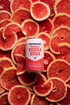 a can of vodka soda surrounded by grapefruits