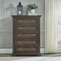 a tall wooden dresser sitting next to a window