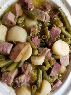 a white plate topped with meat and green beans