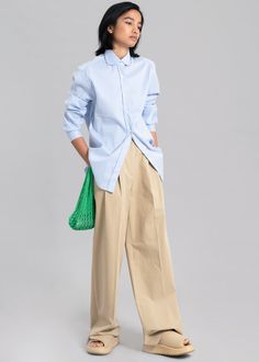 Color: Blue Stripe Woven shirting fabric Regular fit Rounded collar Curved hem Button cuffs Button front closure 96% Polyester 4% PU Dry Clean By The Frankie Shop. Imported Product Measurements: S- 17" Shoulder, 40" Bust, 27.5" Length M- 17.5" Shoulder, 42" Bust, 28" Length L- 18" Shoulder, 44" Bust, 28.5" Length XL- 18.5" Shoulder, 46" Bust, 29" Length Model is 174cm/ 5'8" wearing size S Spring Button-up Shirt With Concealed Placket, Spring Button-up Dress Shirt With Concealed Placket, Spring Workwear Dress Shirt With Concealed Placket, Spring Workwear Shirt With Hidden Button Closure, Light Blue Button Cuffs Shirt For Work, Light Blue Workwear Shirt With Placket, Spring Dress Shirt With Placket For Daywear, Light Blue Relaxed Fit Blouse For Work, Light Blue Shirt With Spread Collar