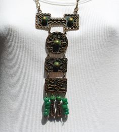 This handsome, handmade mixed metal necklace was produced by Casa Maya Mexico.  The necklace was well-made, and is stamped MEXICO on the back.  Metals include copper and brass, plus dyed green onyx stones and green plastic beads. The necklace has four pendant drops composed of a combination of green onyx beads, green plastic beads on the outer sides, and copper and brass arrow-shaped components.  All links in the neck chain are soldered closed.  Estimated age is the 1950s - 1960s -- mid century Green Artisan Necklace With Patina, Artisan Green Necklace With Patina, Unique Green Patina Necklaces, Hand Forged Green Bohemian Necklace, Green Bohemian Hand Forged Necklace, Collectible Bohemian Copper Necklace, Artisan Green Copper Necklace, Bohemian Patina Necklaces Collectible, Vintage Patina Jewelry For Festivals