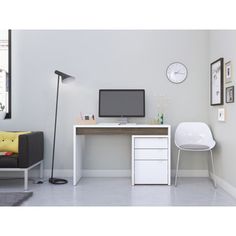 a white desk and chair in a room with a clock on the wall above it