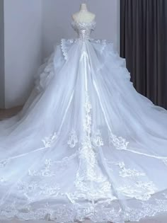 a white wedding dress on display in front of a window