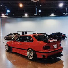 several cars are parked in a garage with no one around them or on the floor