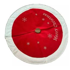 a red and white christmas tree skirt with snowflakes on the bottom that says merry