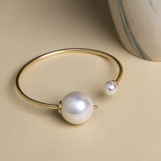 Beautiful Handmade Gold Plated Bracelet with Big & Small Shell Pearl. A dainty wedding gift! Details: Brass Metal Handmade Bracelet Gold Plated Hypoallergenic Lightweight Adjustable Bangle Bracelet Minimal Style *Care: Do not use perfumes or sanitizers around or on the jewelry. Clean it with a cotton cloth. **The Piece is handmade and may have some difference from the reference image. Minimal Gold Bracelet, Dainty Pearl Bracelet, Bracelet Minimal, Pearl Bracelet Wedding, Pearl Bracelet Gold, Minimal Gold, Heavy Earrings, Adjustable Bangle Bracelet, Bracelet Wedding