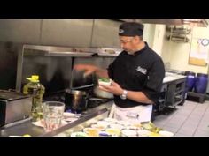 a man standing in a kitchen preparing food