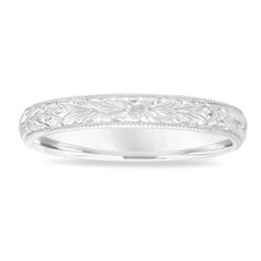 a white gold wedding band with engraved leaves