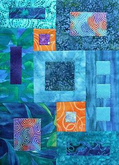 a quilt made with blue and orange squares on top of each other in different colors