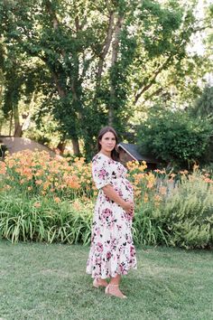 Remain a blooming vision in our Catalina Dress. This lovely dress features a hard-to-miss pink floral print that will remind you to stop and smell the roses. The full-length tiered skirt and half sleeves provide modest coverage for formal occasions. Meanwhile, the stretchy, elastic waistband grants bump-friendly comfort. Pair it with high heels for a look that will make your heart skip a beat. STYLE INFO & CARE Tiered Skirt Fully lined 100% polyester Maternity friendly style Machine Washable in Stop And Smell The Roses, Smell The Roses, Pink Floral Print, Tier Skirt, Lovely Dresses, Floral Midi Dress, Tiered Skirt, Formal Occasion, Half Sleeves