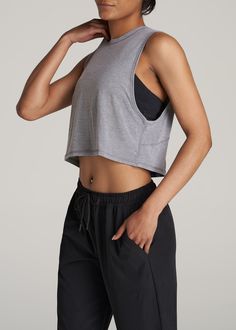 About Our Women's Tall Cropped Muscle Tank Having the right gear makes a difference. Everything about our athletic tank is made to help you smash your workout goals. Constructed with rayon and spandex, this tank won't slow you down. Our women's tall tank has been carefully crafted for women 5'9 to 6'6. Its cropped length ends just above the natural waist and its oversized armhole allows for maximum movement for a distraction-free workout. This athletic tank for tall women has been pre-washed and Muscle Tee Women Outfit, Exercise Shirts For Women, Muscle Tank Outfit Women, Muscle Shirt Outfit Womens, Outfits For Muscular Women, Woman In Tank Top, Muscle Tank Outfit, Sports Shirt Outfit, Female Muscle Reference