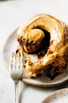 a piece of cake on a plate with a fork next to it and a bite taken out