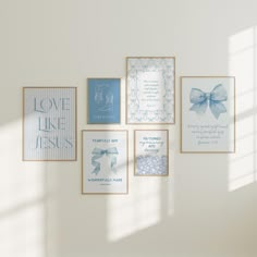 a white wall with blue and white greeting cards on it, framed in wood frames