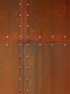 an old rusted metal surface with rivets