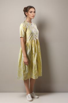 Elevate your summer wardrobe with the Tiska New York Yellow Patterned Cotton Casual Short Sleeve Summer Midi Dress. This knee-length dress features a chic and modest fit-and-flare style, perfect for a casual day out or dressing up for an elegant occasion. Patterned design in a beautiful yellow colored dress Half sleeves style that is perfect for warmer seasons Crafted from 100% cotton material, making it comfortable and breathable Hand wash only for easy care instructions Made in India with high-quality craftsmanship This dress is versatile enough to wear during spring and summer months. Its casual yet boho-chic style makes it suitable to wear on any occasion. It's sweet, minimalist design makes it the perfect choice if you're looking to show off your elegant sense of style while remaining Spring Cotton Midi Dress, Casual Cotton Midi Dress Knee-length, Casual Cotton Knee-length Midi Dress, Cotton Midi Fit And Flare Dress Knee-length, Casual Mid-length Cotton Dress, Cotton Midi Dress For Summer, Cotton A-line Fit And Flare Midi Dress, Cotton Short Sleeve Sundress For Spring, Spring Cotton Sundress With Short Sleeves