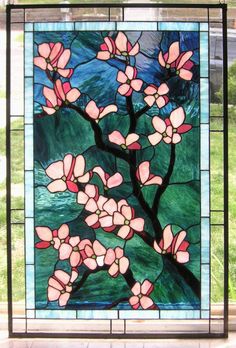 a stained glass window with pink flowers on it