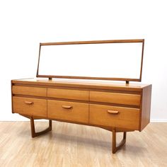 a large wooden dresser sitting on top of a hard wood floor