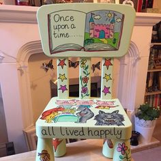 a child's wooden chair with an open book on it and the words, once upon a time, all i lived happily